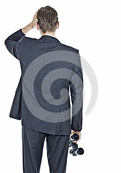 Businessman worried and holding binocular