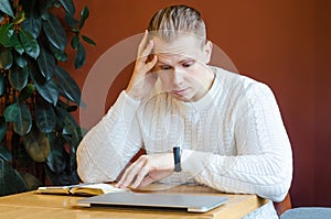 Businessman worried by time when looking at his wristwatch. man looks at  watch and holds his head in shock.