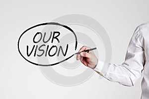 Businessman writes our vision with an outline circle. Business marketing