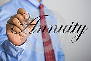 Businessman writing Annuity word on virtual screen photo