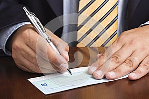 Businessman Writing Blank Check Ballpoint Tie photo