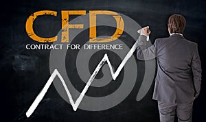 Businessman writing CFD on blackboard concept