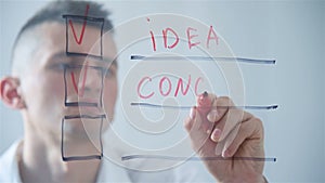 Businessman writing checklist on transparent screen.