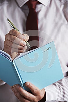 Businessman Writing In 2015 Diary