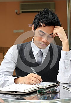 Businessman writing a diarybook