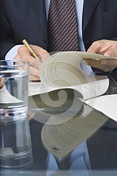 Businessman writing in a document