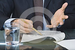 Businessman writing in a document