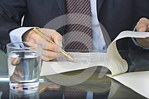 Businessman writing in a document