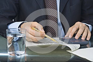 Businessman writing in a document