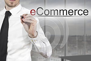 Businessman writing ecommerce in the air