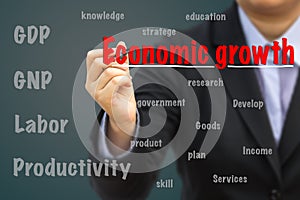 Businessman writing Economic growth relation concept.