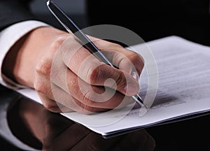 Businessman writing on a form