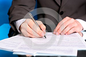 Businessman writing on a form