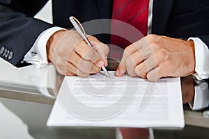 Businessman writing on a form