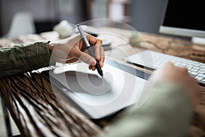 Businessman Writing On Graphic Tablet