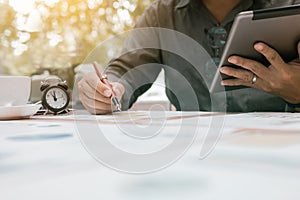 Businessman writing make note on desk office and analysis business corporate.