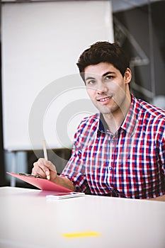 Businessman writing on note pad