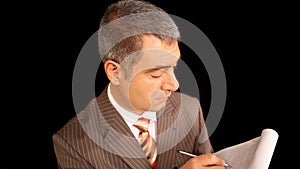 Businessman writing on notepad