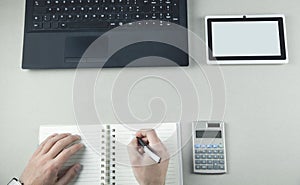 Businessman writing on notepad in business desk. Space for your text