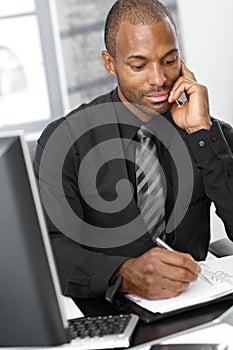 Businessman writing notes