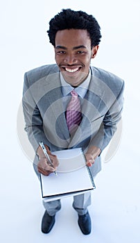 Businessman writing notes in a notebook