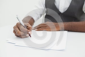 Businessman writing notes on paper