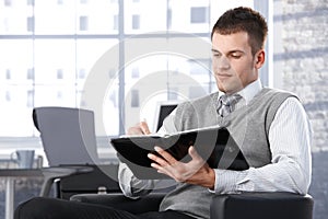 Businessman writing notes to personal organizer