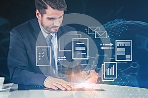 Businessman writing in office, electronic document