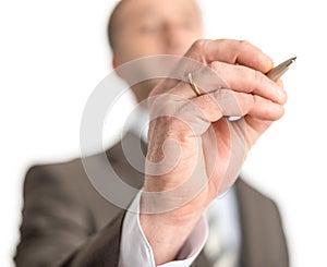 Businessman writing with pen on screen