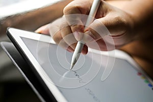 Businessman writing touch pad on wording Business.