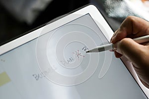 Businessman writing touch pad on wording Business.