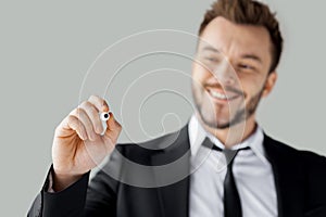 Businessman writing on transparent wipe board.