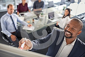 Businessman writing on whiteboard during brainstorming