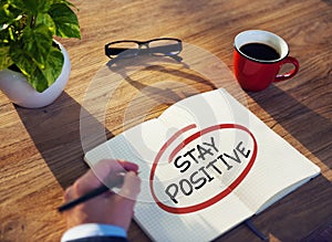 Businessman Writing the Words Stay Positive