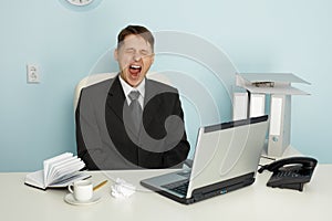 Businessman yawning from boredom and idleness