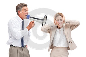 Businessman yelling at his coworker with megaphone