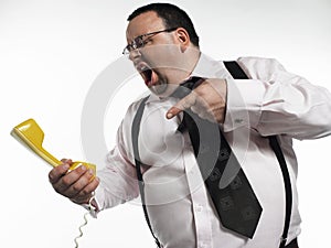 Businessman Yelling At Telephone Receiver