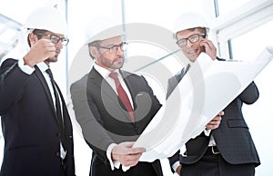 Businessmen and architects inspect the new building