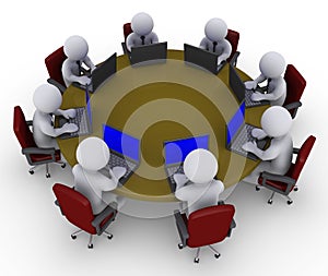 Businessmen around table with laptops