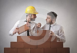 Businessmen building wall