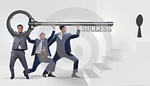 Businessmen in business success concept with key