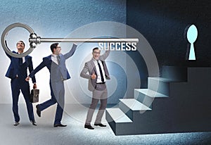 Businessmen in business success concept with key