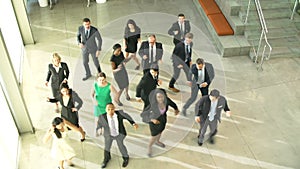 Businessmen And Businesswomen Dancing In Office Lobby