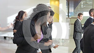 Businessmen And Businesswomen Dancing In Office Lobby