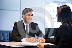 Businessmen and Businesswomen discussing documents for job interview concept