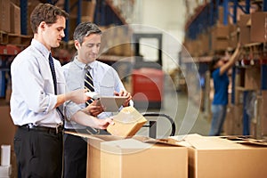 Businessmen Checking Boxes With Digital Tablet And Scanner