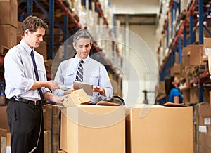 Businessmen Checking Boxes With Digital Tablet And Scanner