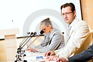 Businessmen communicate at the conference