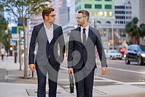 Businessmen communicating at meeting. Two businessmen discussing outdoor during business meeting. Businessmen talking