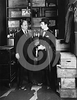 Businessmen conversing in storeroom photo